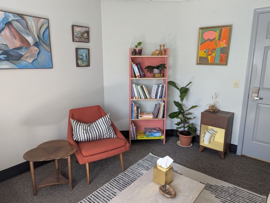 A photo of a chair and bookshelf
